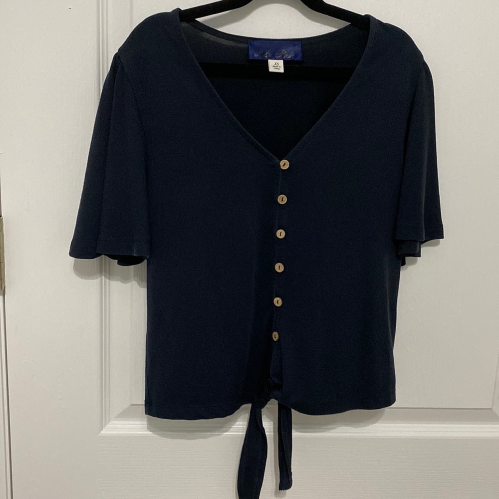Francesca’s “Blue Rain” flutter sleeve top with buttons and tie waist in navy